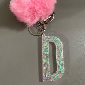 Letter D keychain with pink puff ball